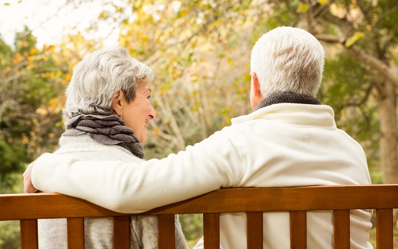 retired couple on bench park